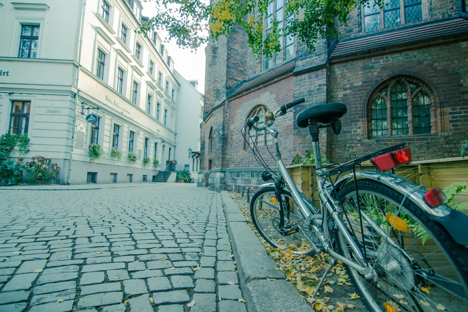 Bikes parked on the side of a house in a Berlin neighborhood.